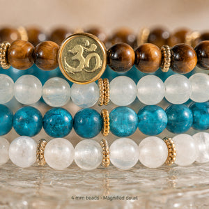 Magnified detail of the four Abundance bracelet rows showing 4 mm gemstone beads, gold spacers and Soultheory's actual photographed charm