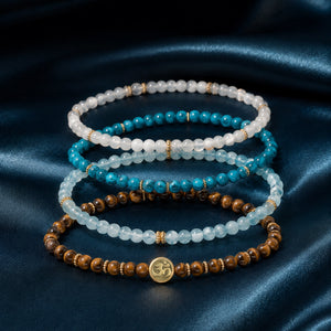 Abundance option A3: Tiger's Eye, Aquamarine, Apatite and Moonstone bracelet set with Soultheory charm on deep teal silk