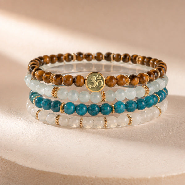 Abundance option A5: four-bracelet crystal stack with Soultheory charm on a pale blush sculptural display