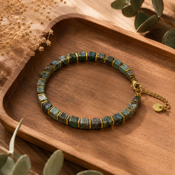 African turquoise bracelet flat lay on a wooden tray with eucalyptus leaves - Soultheory