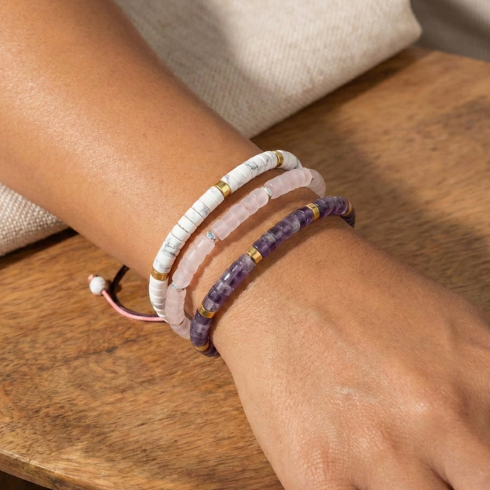 Amethyst, howlite and rose quartz emotional reset bracelet set laid on wood for calm - Soultheory India