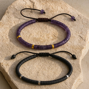 Black onyx protection bracelet paired with amethyst bracelet on stone, gold and silver accent beads