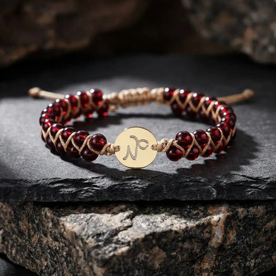 Capricorn zodiac energy stone bracelet with gold sign charm and deep red garnet beads for ambition - Soultheory India