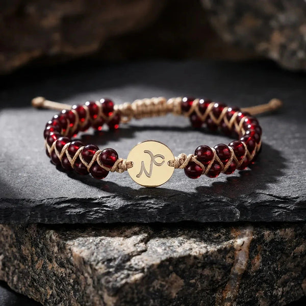 Capricorn zodiac energy stone bracelet with gold sign charm and deep red garnet beads for ambition - Soultheory India