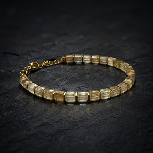 Citrine bracelet with golden hematite spacers arranged flat lay on dark slate, Soultheory finish