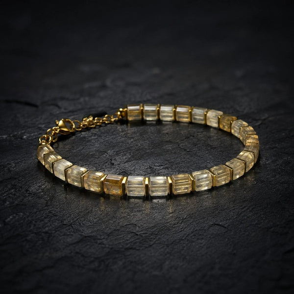 Citrine bracelet with golden hematite spacers arranged flat lay on dark slate, Soultheory finish