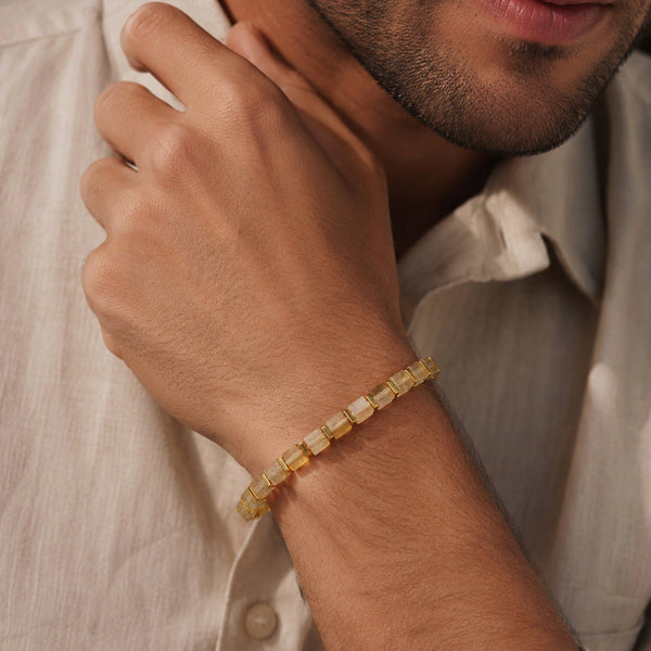 Citrine bracelet with golden hematite styled on a man's wrist for everyday abundance