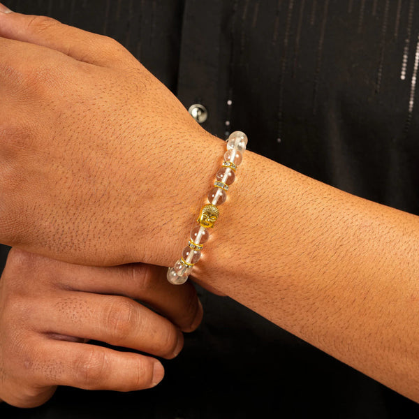 Clear quartz Sphatik bracelet worn on wrist with gold Buddha and crystal spacer beads