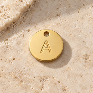 Example A gold-coloured stainless-steel initial charm - choose one letter A-Z