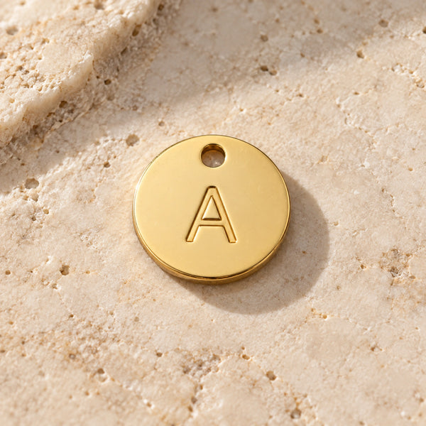 Example A gold-coloured stainless-steel initial charm - choose one letter A-Z