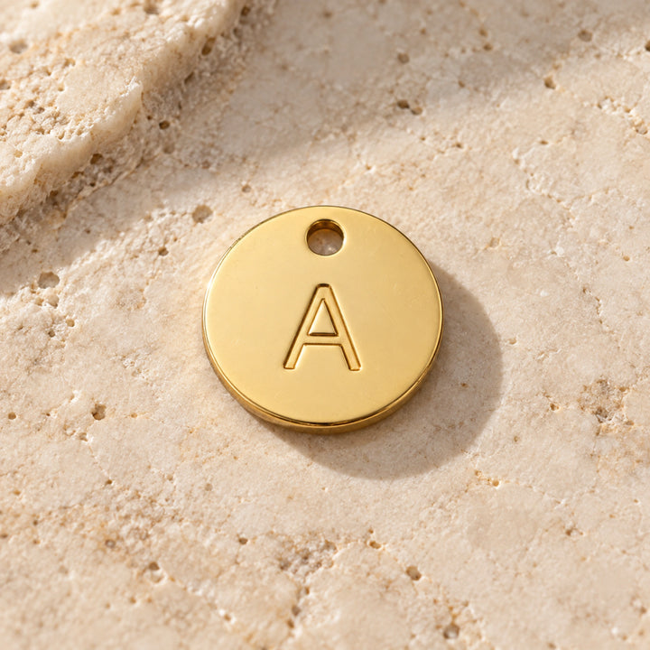 Example A gold-coloured stainless-steel initial charm - choose one letter A-Z