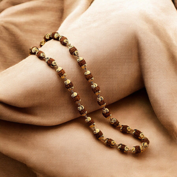Modern gold plated rudraksha mala with 5 mukhi beads draped on soft fabric for daily devotion - Soultheory India