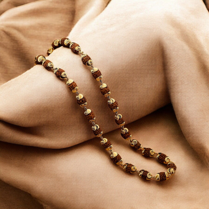 Modern gold plated rudraksha mala with 5 mukhi beads draped on soft fabric for daily devotion - Soultheory India