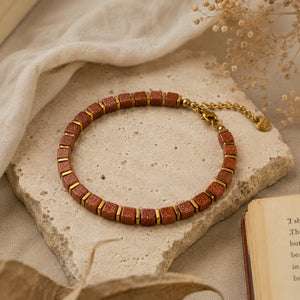Goldstone bracelet flat lay styled with dried flowers and an open book - Soultheory
