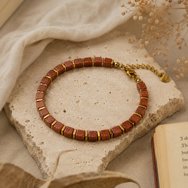 Goldstone bracelet flat lay styled with dried flowers and an open book - Soultheory