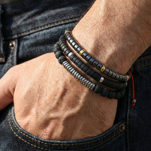 Man wearing the grounding combo of hematite, onyx and lava rock bracelets stacked on his wrist with jeans