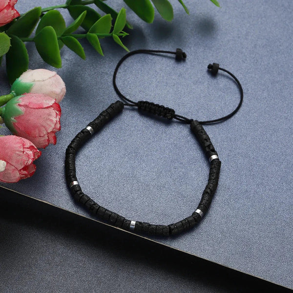 Black lava rock bracelet with silver spacer beads and adjustable cord for stability and strength