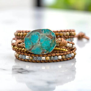 Ocean jasper wrap bracelet on marble showing gold nugget beads and multi-strand leather design