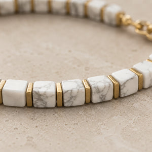 Close-up of white howlite cube beads with grey veining and gold hematite spacers, Soultheory detail