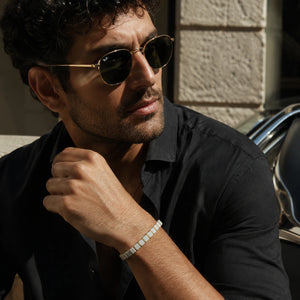 Howlite bracelet with golden hematite worn by a man in black for a calm minimal look