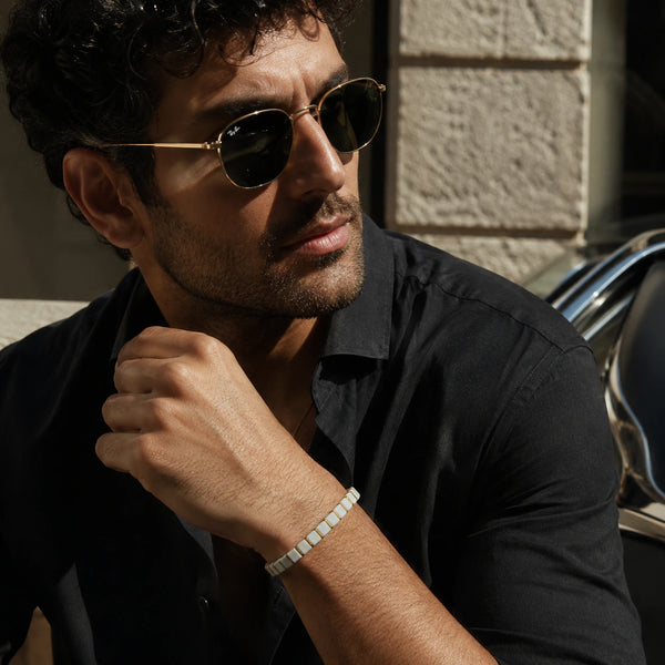 Howlite bracelet with golden hematite worn by a man in black for a calm minimal look