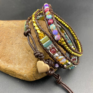 Imperial jasper wrap bracelet coiled on a stone showing jasper, crystal and gold beaded strands