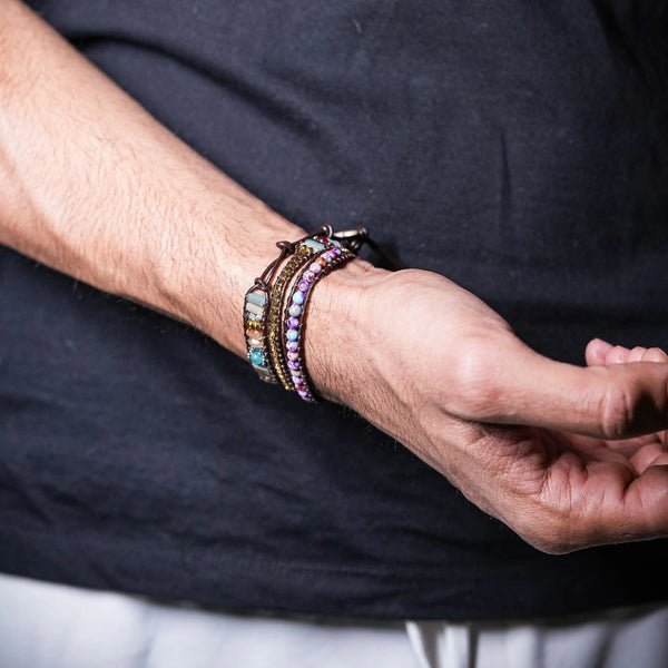 Imperial jasper leather wrap bracelet on a man's wrist with a navy shirt, colourful beaded rows