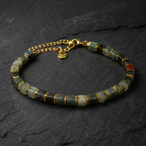 Indian agate bracelet with golden hematite spacers displayed on dark slate stone - Soultheory