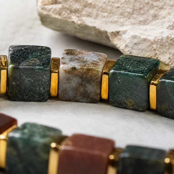 Close-up of multicolour Indian agate cube beads showing deep green, red and quartz tones