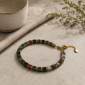 Indian agate bracelet with golden hematite styled beside a ceramic bowl - Soultheory