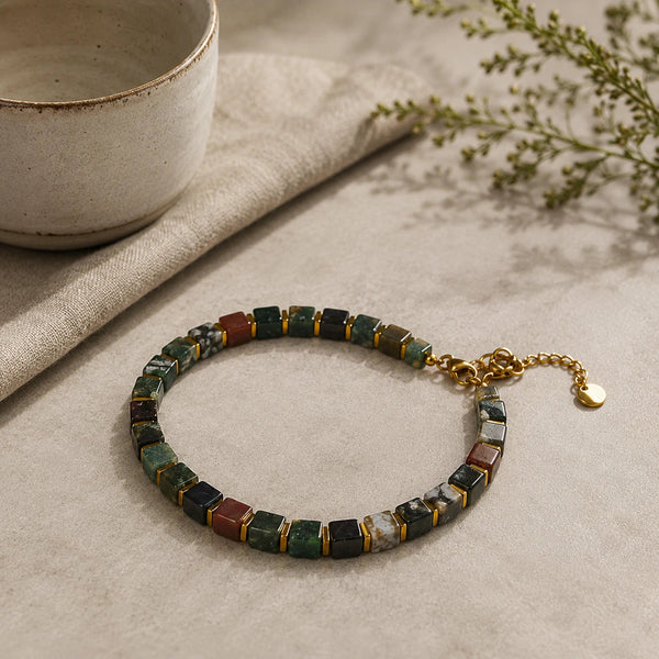 Indian agate bracelet with golden hematite styled beside a ceramic bowl - Soultheory