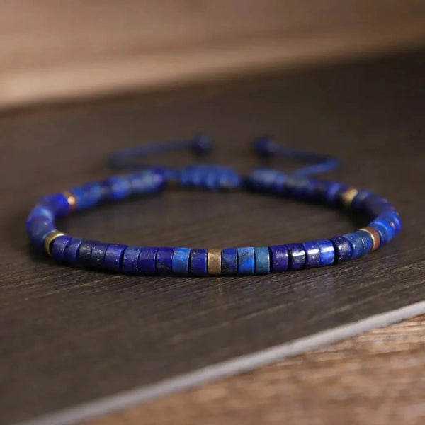 Close-up of lapis lazuli heishi beads with brass accents for wisdom and calm focus