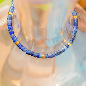 Close-up of lapis lazuli beads with gold spacers and golden pyrite flecks