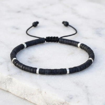 Natural black onyx bracelet with silver accents on adjustable cord for protection and strength - Soultheory India