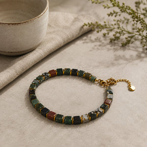 Dragon stone bracelet with golden hematite styled beside a ceramic bowl - Soultheory