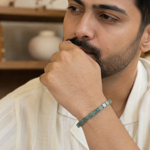 Green aventurine bracelet with golden hematite on a man's wrist, cube green beads for everyday luck