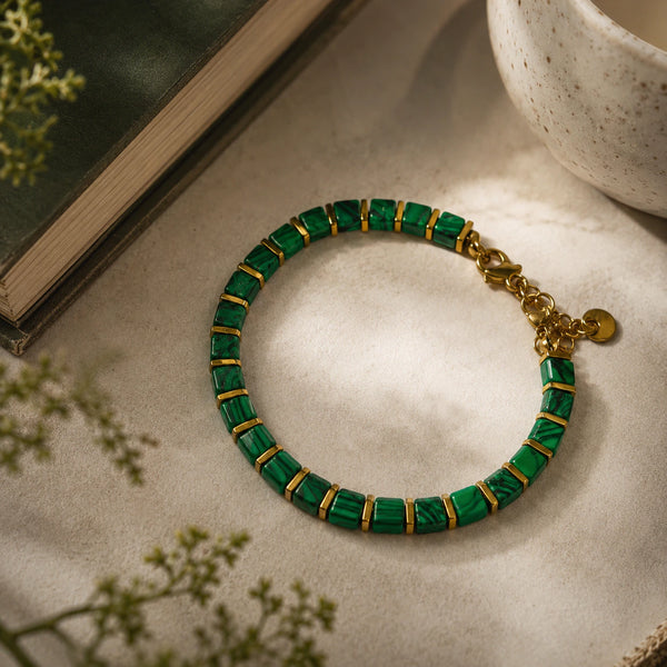 Malachite and golden hematite bracelet styled beside a book and cup for calm and focus