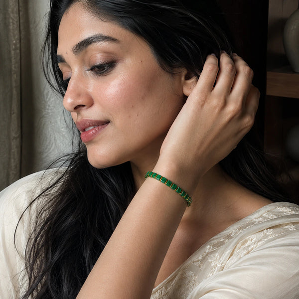 Malachite bracelet with golden hematite worn on a woman's wrist in a cream saree, Soultheory