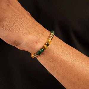 Money magnet bracelet worn on the wrist showing pyrite, tiger eye and green aventurine beads