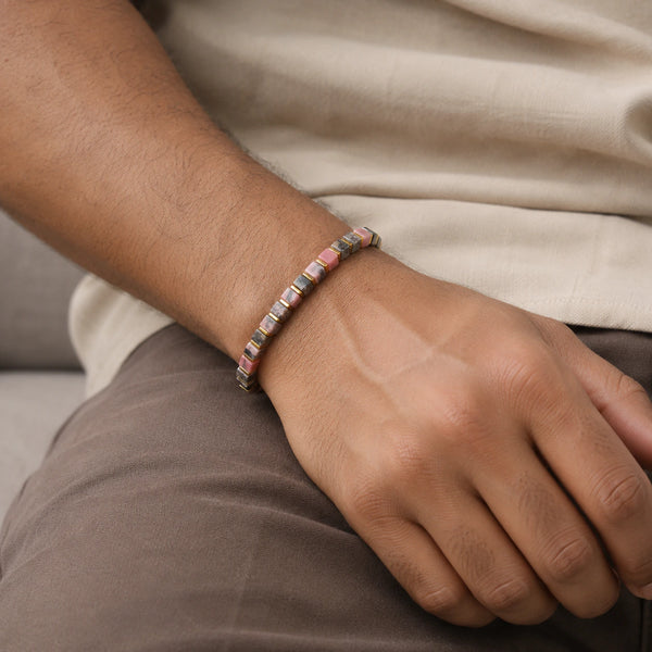 Rhodolite garnet bracelet with golden hematite worn on a man's wrist in a cream shirt, Soultheory