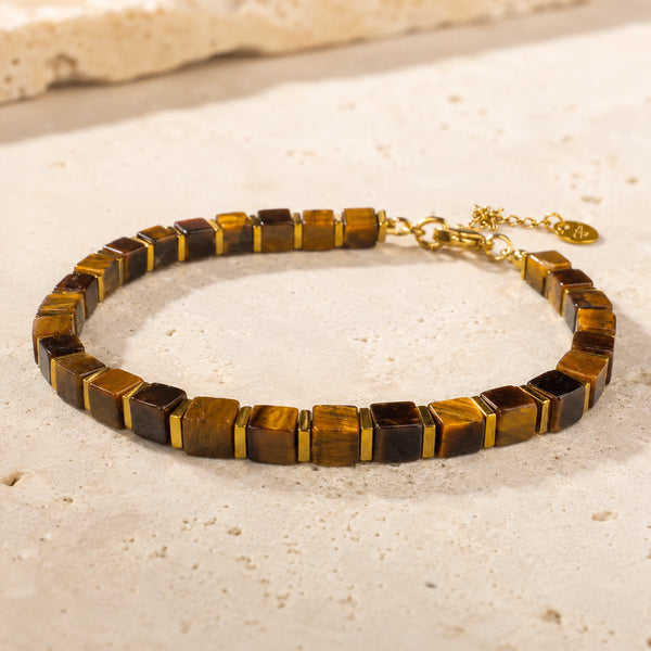 Tiger eye bracelet with golden hematite on pale travertine, adjustable gold chain and clasp shown