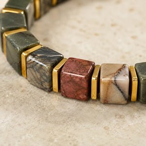 Close-up of square Picasso jasper cube beads with gold hematite spacers showing natural earthy patterns