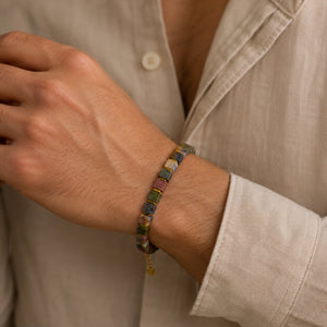 Picasso jasper square bead bracelet with golden hematite worn on a man's wrist