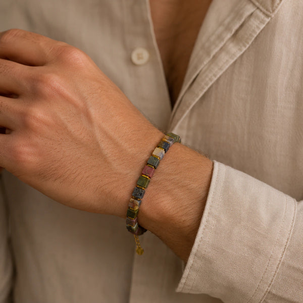 Picasso jasper square bead bracelet with golden hematite worn on a man's wrist