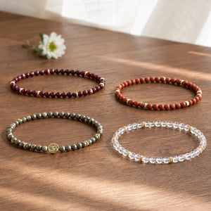 Prosperity 4 mm crystal bracelet stack - four bracelets on a sunlit table
