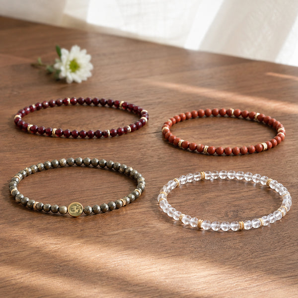 Prosperity 4 mm crystal bracelet stack - four bracelets on a sunlit table