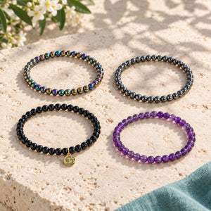 Soultheory Protection Bracelet Stack - Rainbow Hematite, Hematite, Black Tourmaline & Amethyst (Set of 4) - 4 separate bracelets laid out naturally