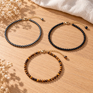 Soultheory Protection Anklet Set - Hematite, Black Obsidian & Tiger's Eye (3 Pieces) - 3 separate anklets laid out naturally