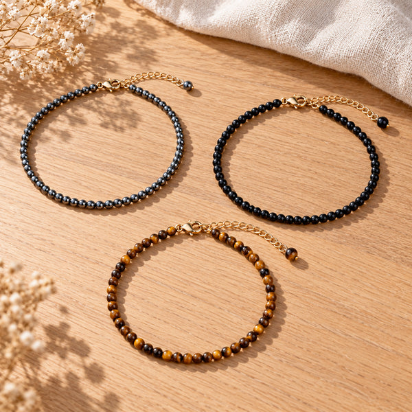 Soultheory Protection Anklet Set - Hematite, Black Obsidian & Tiger's Eye (3 Pieces) - 3 separate anklets laid out naturally