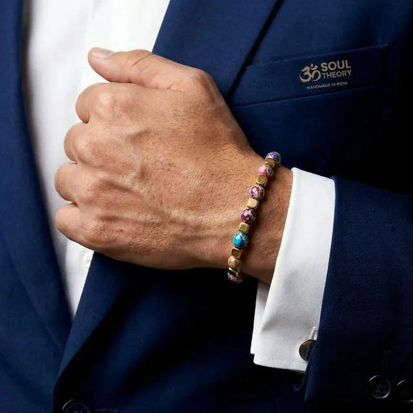 Purple jasper bracelet worn on wrist with navy suit, colourful beads and stainless steel chain